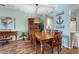 Open dining room with wooden furniture and stylish decorations next to an open concept kitchen at 2080 Cross Gate Blvd. # 303, Surfside Beach, SC 29575
