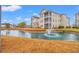 Scenic condo community with a tranquil pond and fountain surrounded by well-maintained landscaping at 2080 Cross Gate Blvd. # 303, Surfside Beach, SC 29575