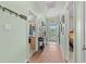 Inviting hallway with wood floors, offering views into adjoining rooms and outdoor scenery at 2080 Cross Gate Blvd. # 303, Surfside Beach, SC 29575