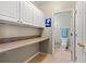 Functional laundry room with cabinets, counter space, and an adjacent half bathroom at 2080 Cross Gate Blvd. # 303, Surfside Beach, SC 29575