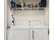 White washer and dryer set, complemented by a wire shelf with laundry supplies at 2080 Cross Gate Blvd. # 303, Surfside Beach, SC 29575
