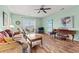 Comfortable living room with hardwood floors, a ceiling fan and lots of natural light from the sliding glass door at 2080 Cross Gate Blvd. # 303, Surfside Beach, SC 29575