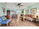 Bright, open-concept living space with hardwood floors, stylish furnishings, and a combined living and dining area at 2080 Cross Gate Blvd. # 303, Surfside Beach, SC 29575