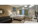 Well-lit bedroom features a queen bed, seating area, and decorative wall art at 241 Presidential Dr., Surfside Beach, SC 29575