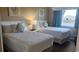 Comfortable bedroom featuring two twin beds, soft linens, and nautical-themed decor at 241 Presidential Dr., Surfside Beach, SC 29575
