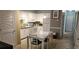 A bright, all-white kitchen and dining area with modern appliances and ample cabinet space at 241 Presidential Dr., Surfside Beach, SC 29575