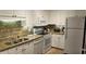 A well-equipped kitchen with granite countertops, white appliances, and ample storage space at 241 Presidential Dr., Surfside Beach, SC 29575