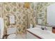 Small bathroom with shower, sink, and patterned wallpaper at 25 Frigate Ct., Pawleys Island, SC 29585