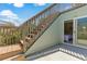 Deck stairs leading to bedroom with sliding glass door access at 25 Frigate Ct., Pawleys Island, SC 29585
