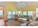 Living room with vaulted ceilings, access to deck, and comfy seating at 25 Frigate Ct., Pawleys Island, SC 29585
