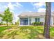 Single-story home with screened porch and grassy backyard at 257 Connemara Dr. # E, Myrtle Beach, SC 29579
