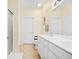 Bathroom with double sinks, white cabinets, and a shower at 257 Connemara Dr. # E, Myrtle Beach, SC 29579