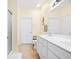 Bathroom with double sinks, white cabinets, and a shower at 257 Connemara Dr. # E, Myrtle Beach, SC 29579