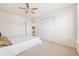 Bedroom with a queen-size bed, double doors, and ceiling fan at 257 Connemara Dr. # E, Myrtle Beach, SC 29579