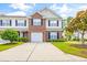 Brick front two-story townhome with attached garage and landscaping at 257 Connemara Dr. # E, Myrtle Beach, SC 29579