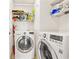 Bright laundry room with washer, dryer, and ample shelving at 257 Connemara Dr. # E, Myrtle Beach, SC 29579