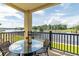 Outdoor dining on covered balcony with a view of the water at 265 Venice Way # 1101, Myrtle Beach, SC 29577