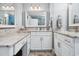 Elegant bathroom with dual sinks, marble countertops, white cabinets, and a spacious mirror at 265 Venice Way # 1101, Myrtle Beach, SC 29577