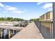 Waterfront property featuring a private boat dock and walkway access on a sunny day at 265 Venice Way # 1101, Myrtle Beach, SC 29577