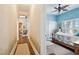 Hallway leads to a bedroom with blue walls, wood floors, and plantation shutters at 265 Venice Way # 1101, Myrtle Beach, SC 29577