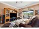 Spacious living room featuring a large entertainment center, comfortable seating, and access to the outdoor balcony at 265 Venice Way # 1101, Myrtle Beach, SC 29577