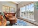 Cozy sitting room boasts a plush leather sofa, matching ottoman, and large windows overlooking a tranquil lake at 265 Venice Way # 1101, Myrtle Beach, SC 29577