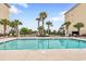 Community pool with palm trees and plenty of lounge chairs available at 265 Venice Way # 1101, Myrtle Beach, SC 29577
