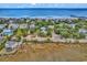 Aerial view of beach house near ocean, showing surrounding houses and marsh at 298 Myrtle Ave., Pawleys Island, SC 29585