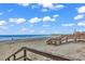 Beachfront property with boardwalk access and pier in the distance at 298 Myrtle Ave., Pawleys Island, SC 29585