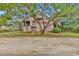 Two-story beach house with screened porch and mature landscaping at 298 Myrtle Ave., Pawleys Island, SC 29585