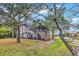 Two-story beach house with wooden staircase and mature landscaping at 298 Myrtle Ave., Pawleys Island, SC 29585