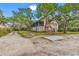 Two-story beach house with screened porch and mature landscaping at 298 Myrtle Ave., Pawleys Island, SC 29585