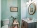 Charming bathroom with light blue walls, an oval mirror, and a modern vanity at 301 North Main St., Hemingway, SC 29554