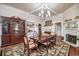 Elegant dining room featuring hardwood floors, a fireplace, and a large dining table at 301 North Main St., Hemingway, SC 29554