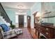 Inviting entryway with hardwood floors, charming seating area, and a grand staircase at 301 North Main St., Hemingway, SC 29554