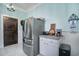 Modern kitchen with stainless steel refrigerator and white cabinets at 301 North Main St., Hemingway, SC 29554
