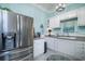 Modern kitchen with white cabinets and stainless steel appliances at 301 North Main St., Hemingway, SC 29554
