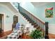 Grand staircase with black railings and light teal walls at 301 North Main St., Hemingway, SC 29554