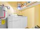 Bright laundry room with washer, dryer, and storage shelves at 303 Flagstone Dr., Myrtle Beach, SC 29588