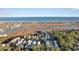 Aerial view showcasing a neighborhood near the coast with marsh and ocean views at 34 Lazy Hammock Trail, Pawleys Island, SC 29585