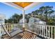 Relaxing balcony with outdoor furniture and neighborhood view at 34 Lazy Hammock Trail, Pawleys Island, SC 29585