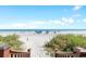 Beach access walkway leading to a sandy beach with umbrellas at 34 Lazy Hammock Trail, Pawleys Island, SC 29585