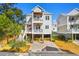 Two-story home with white siding, large windows, and a two-car garage at 34 Lazy Hammock Trail, Pawleys Island, SC 29585