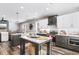 Modern kitchen with a large island, white and gray cabinets, and stainless steel appliances at 34 Lazy Hammock Trail, Pawleys Island, SC 29585