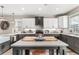 Modern kitchen with two-toned cabinets, an island, and stainless steel appliances at 34 Lazy Hammock Trail, Pawleys Island, SC 29585
