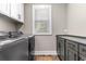 Laundry room with modern washer and dryer and ample counter space at 34 Lazy Hammock Trail, Pawleys Island, SC 29585