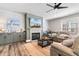 Living room with fireplace, large TV, comfortable seating, and wood-like flooring at 34 Lazy Hammock Trail, Pawleys Island, SC 29585