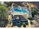 Overhead shot of a home with a pool and lounge area amidst trees and landscaping at 38 Shadow Moss Pl. # 38, North Myrtle Beach, SC 29582