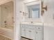 Bright bathroom featuring a tub and shower, with a white vanity and a framed mirror at 38 Shadow Moss Pl. # 38, North Myrtle Beach, SC 29582