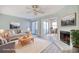 Inviting living room with fireplace, ceiling fan, and view of the dining and outdoor area at 38 Shadow Moss Pl. # 38, North Myrtle Beach, SC 29582